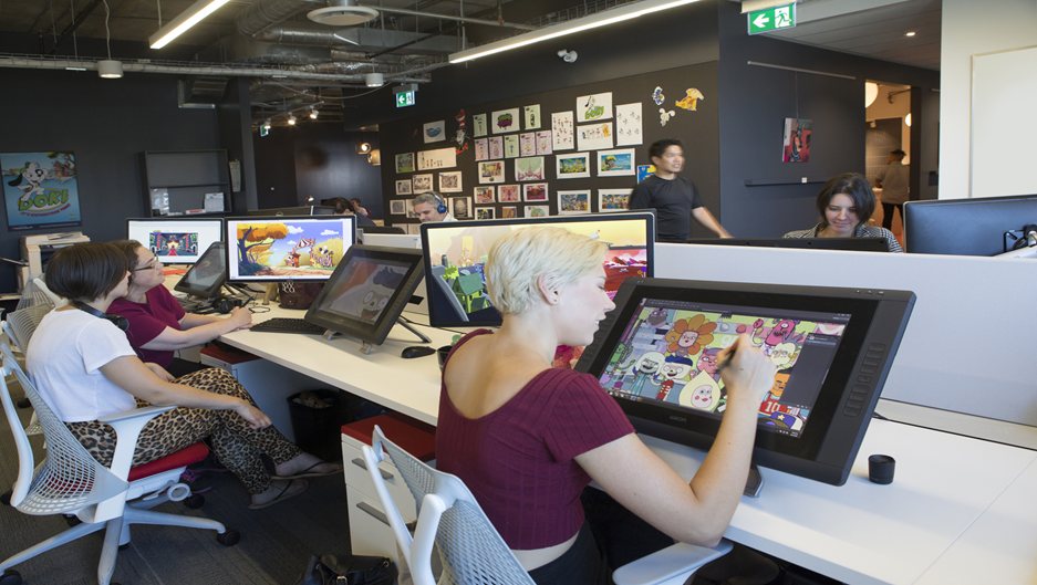 Creators working at digital production workstations in the Areté AI & Digital Creative Lab